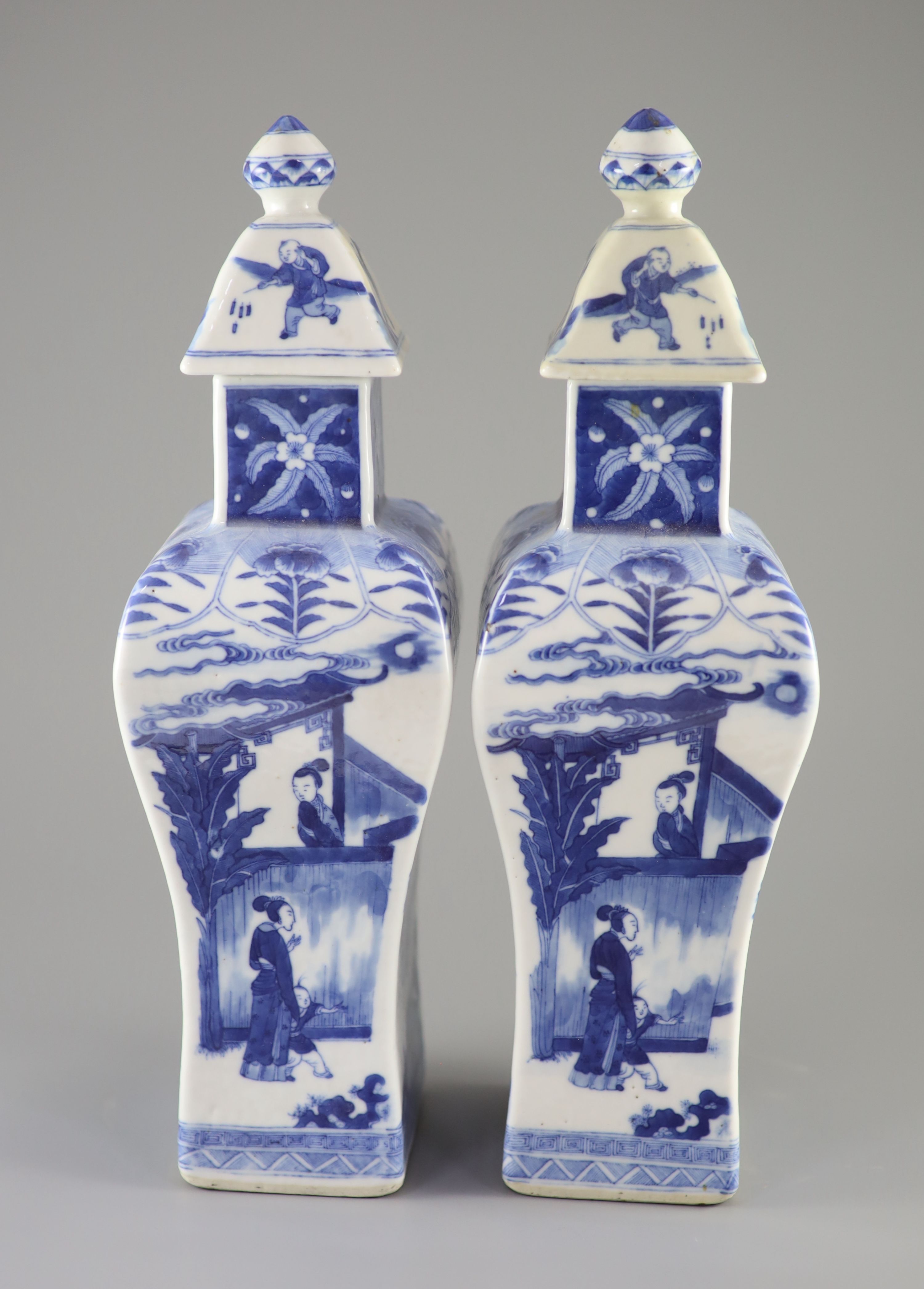 A pair of Chinese blue and white rectangular baluster vases and covers, Kangxi marks but 19th century, 36.5 cm